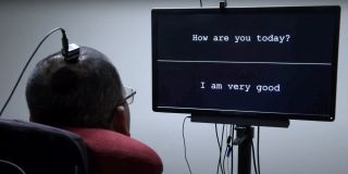 A man using the interface discussed in the link above, looking at a screen. The screen show two section with words. The first shows «How are you today?». The sections shows the answer «I am very good».